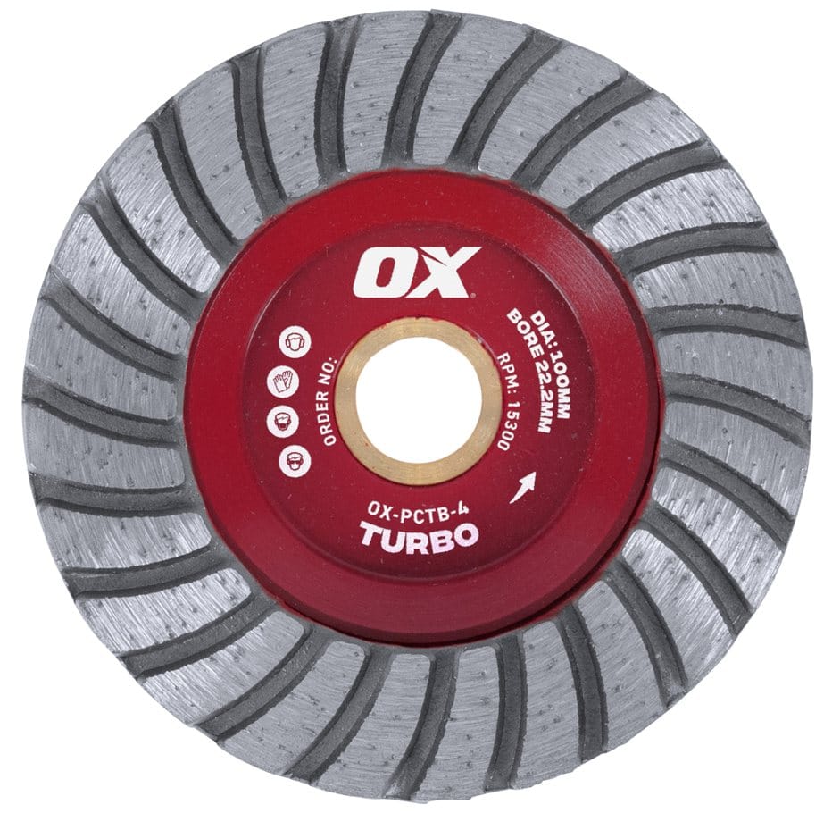 A top-down studio shot of the red OX Professional 4-inch turbo cup wheel, featuring a 22.2mm bore and a spiral pattern of grey diamond grinding segments.