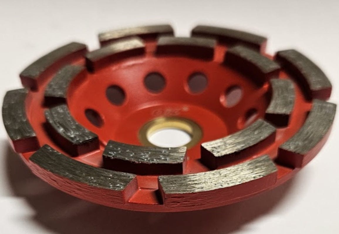 A low-angle perspective of the OX-PCDT-4 diamond cup wheel showcasing the depth and thickness of the industrial diamond segments designed for heavy-duty material removal and smoothing of rough masonry.
