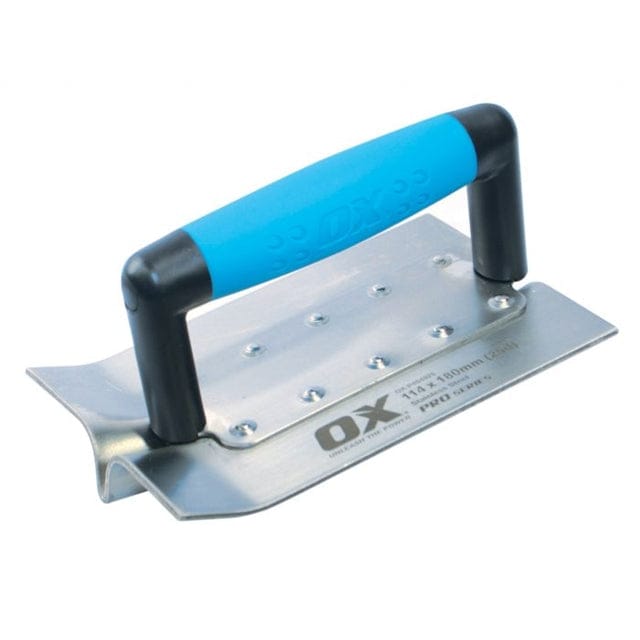 Studio view of the OX Tools Pro stainless steel concrete groover featuring a 4-1/2 inch by 7 inch blade with a deep central bit and a blue and black soft grip handle attached with rivets.