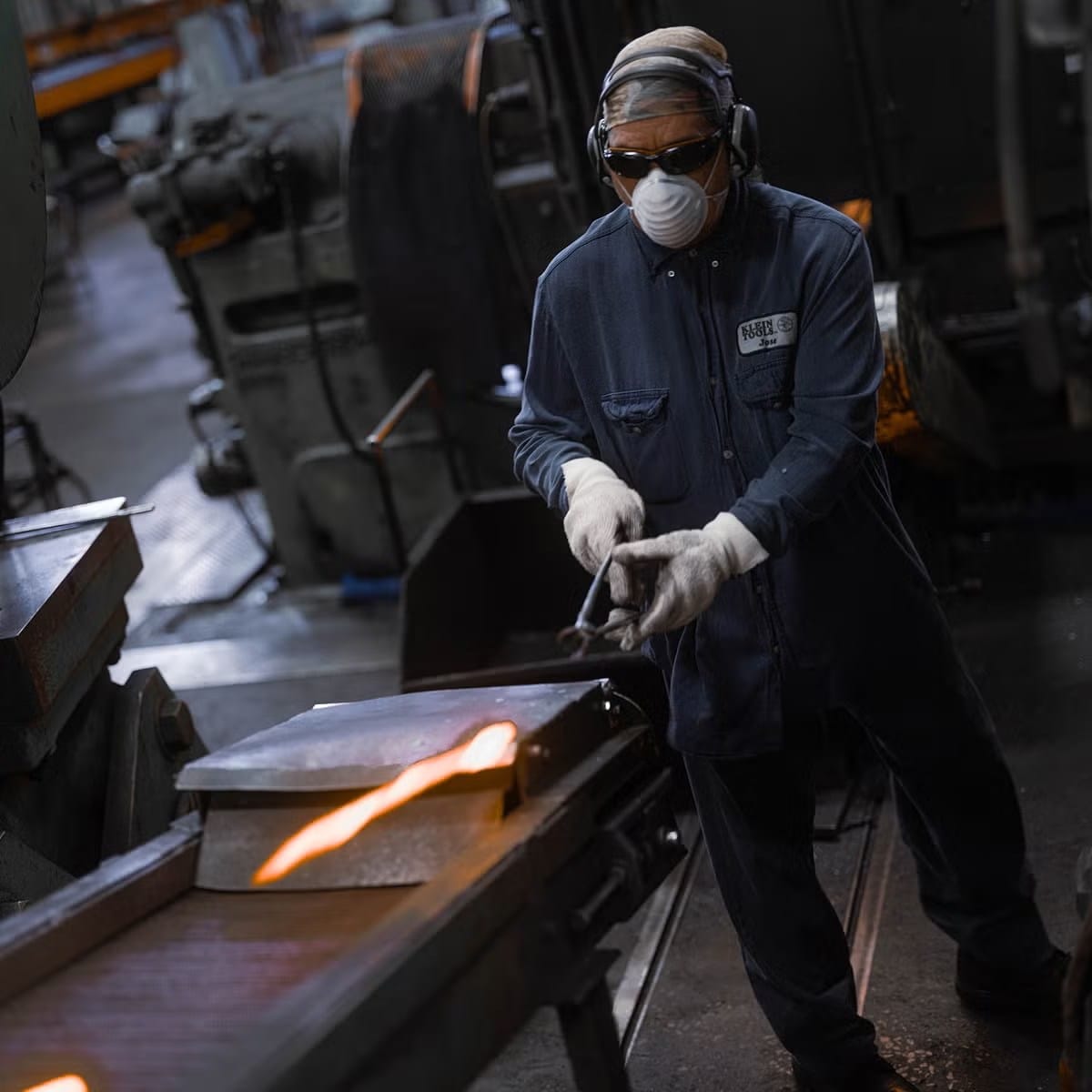 Load video: Person welding metal in a workshop with protective gear