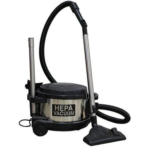Full view of the Pullman-Holt 390ASB 4-gallon HEPA canister vacuum with its metal body, attached hose, extension wand, and floor tool, showing the unit ready for upright use.
