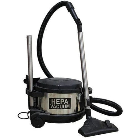 Full view of the Pullman-Holt 390ASB 4-gallon HEPA canister vacuum with its metal body, attached hose, extension wand, and floor tool, showing the unit ready for upright use.