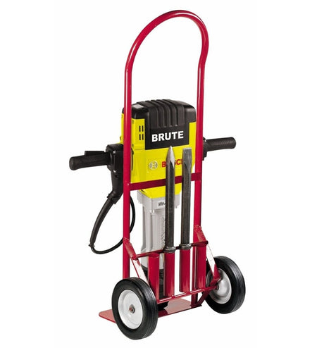 Bosch Brute jackhammer mounted on red hand truck with power cord and three chisel bits secured at the base for transport.