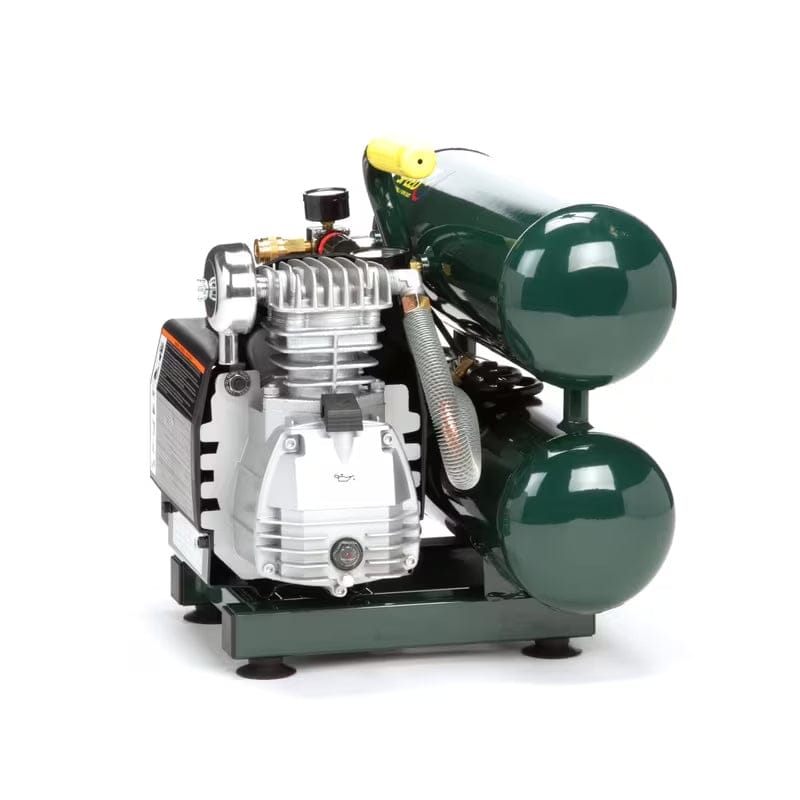 Close-up angled view of the VT20ST pump assembly, clearly showing the silver cast iron pump head, oil sight gauge, and twin air tanks