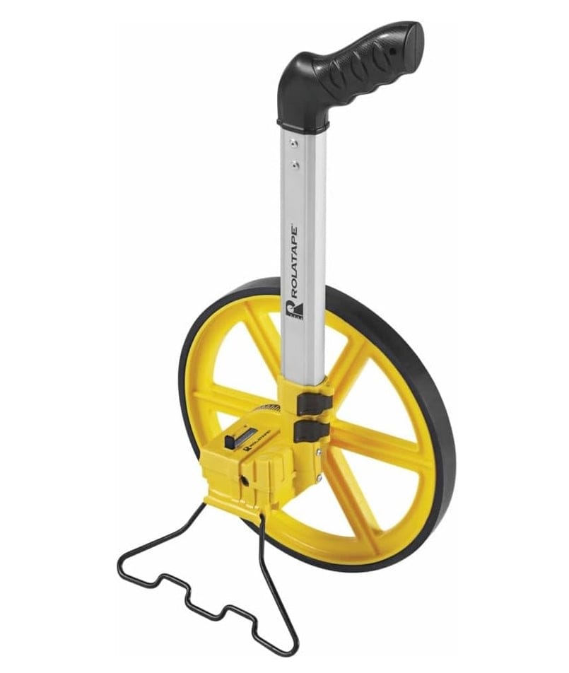An angled view of the Rolatape RT300 outdoor measuring wheel standing upright on its built-in kickstand, showcasing the sturdy spoked wheel design and easy-access reset switch on the counter.