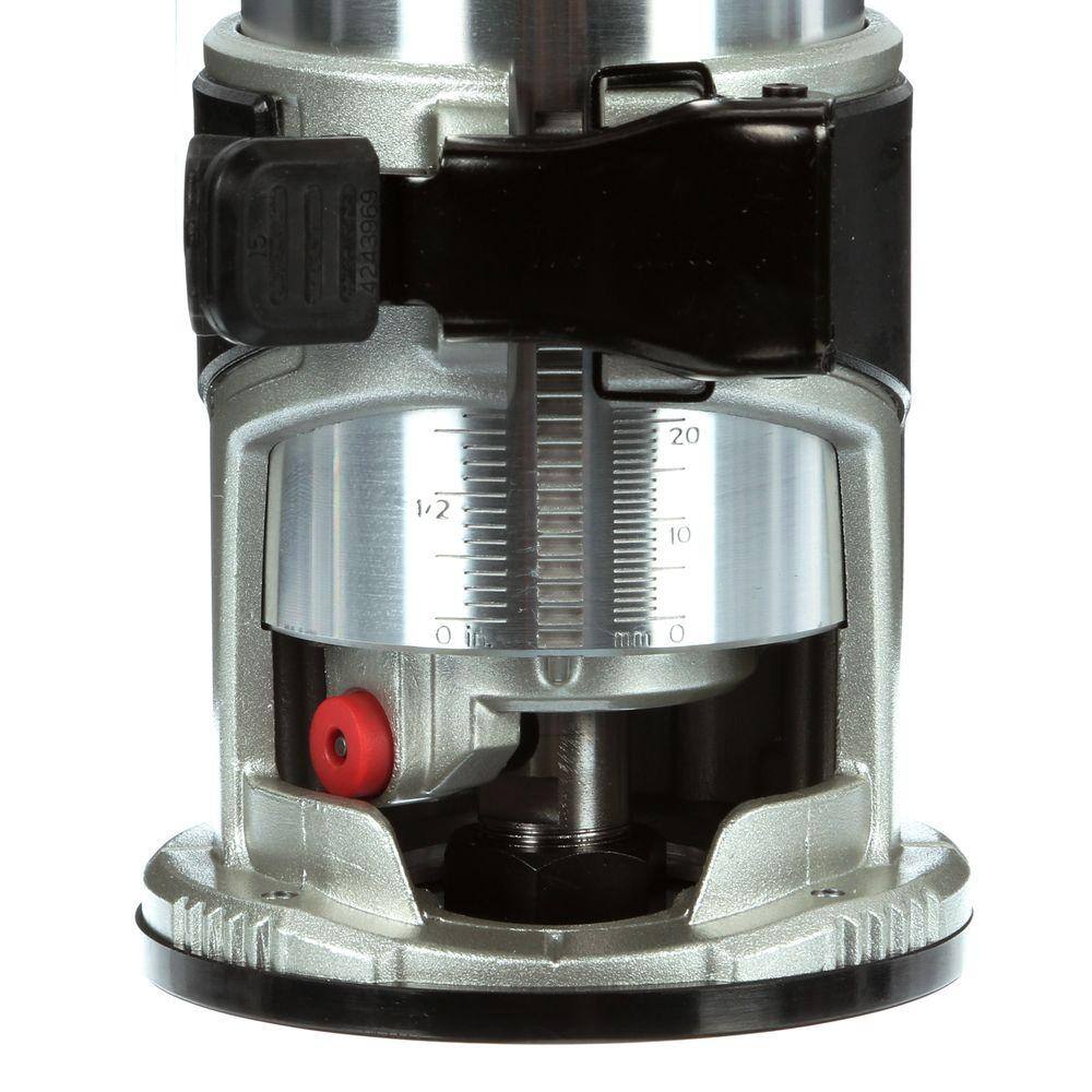 Detailed close-up of the Makita compact router's aluminum housing, featuring easy-to-read depth scales in both inches and millimeters for highly precise routing adjustments.