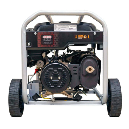 Rear view of the generator showing the silver alternator end cap, black muffler assembly with heat shield, and the wheel axle.