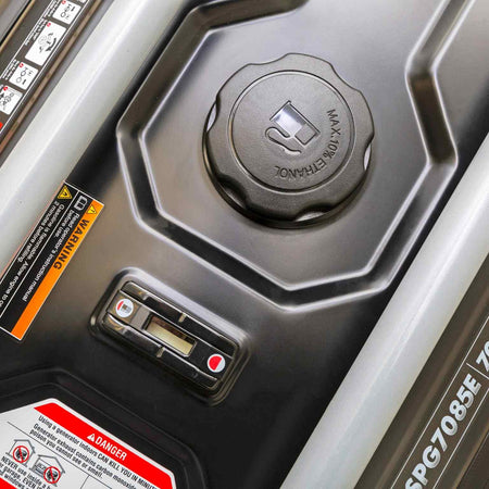 Top-down view of the black 6.1-gallon fuel tank showing the built-in fuel gauge, gas cap, and operational safety labels.