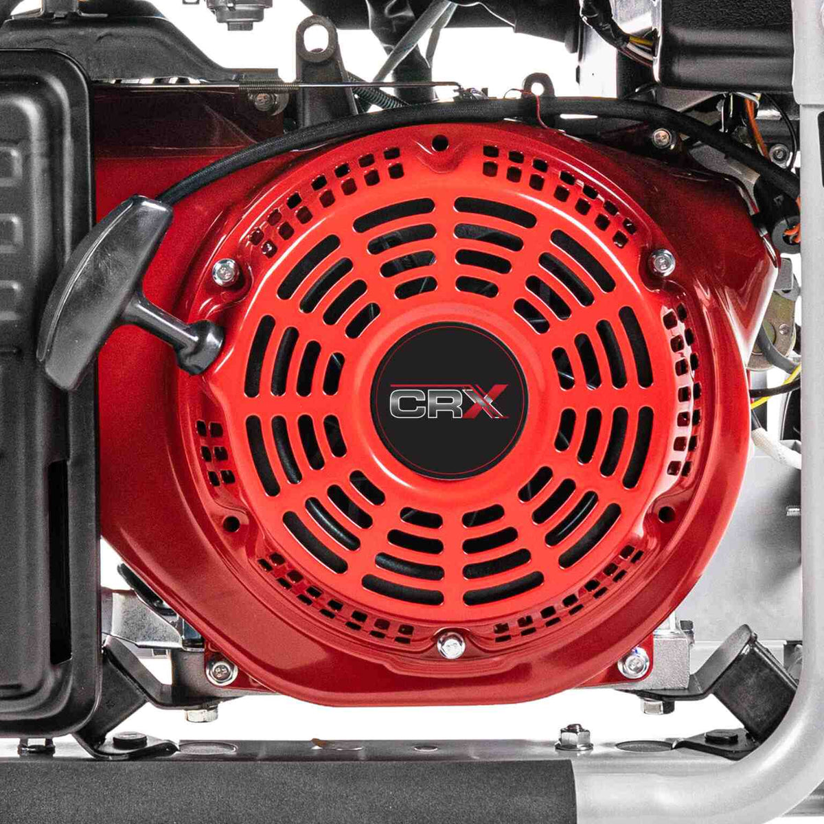 Close up view of the red recoil starter assembly on the CRX engine with the black pull handle and cooling vents.