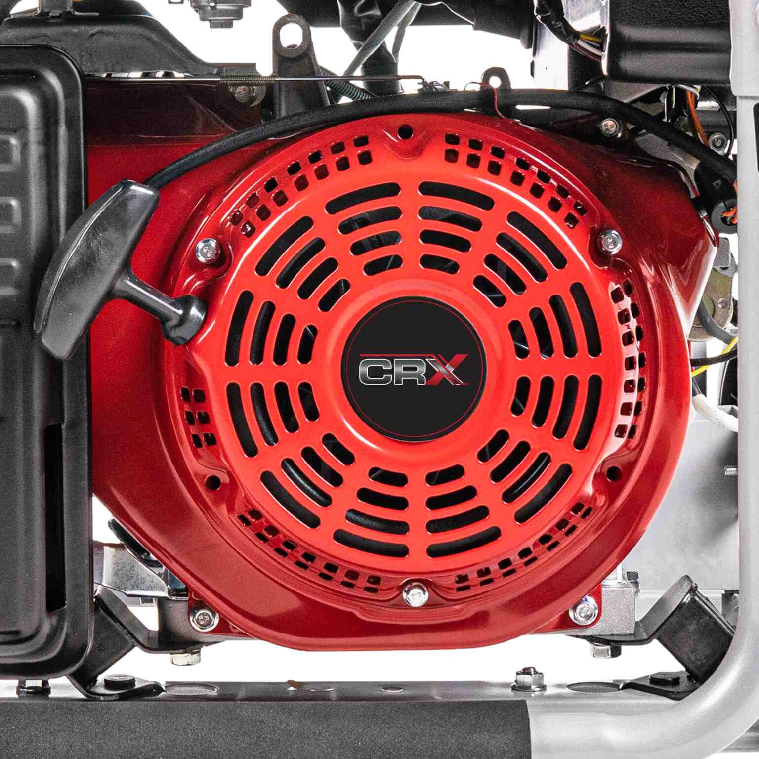 Close up view of the red recoil starter assembly on the CRX engine with the black pull handle and cooling vents.