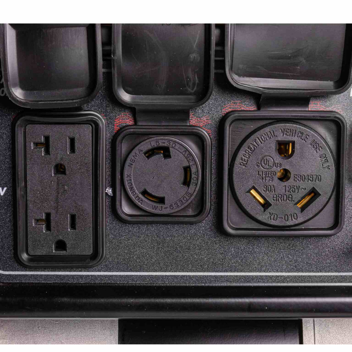 Close-up view of the power outlets showing the 120V duplex, 120V twist lock, and 120V RV-ready receptacle.