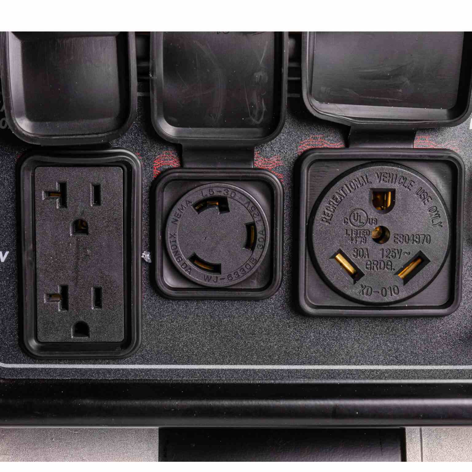 Close-up view of the power outlets showing the 120V duplex, 120V twist lock, and 120V RV-ready receptacle.