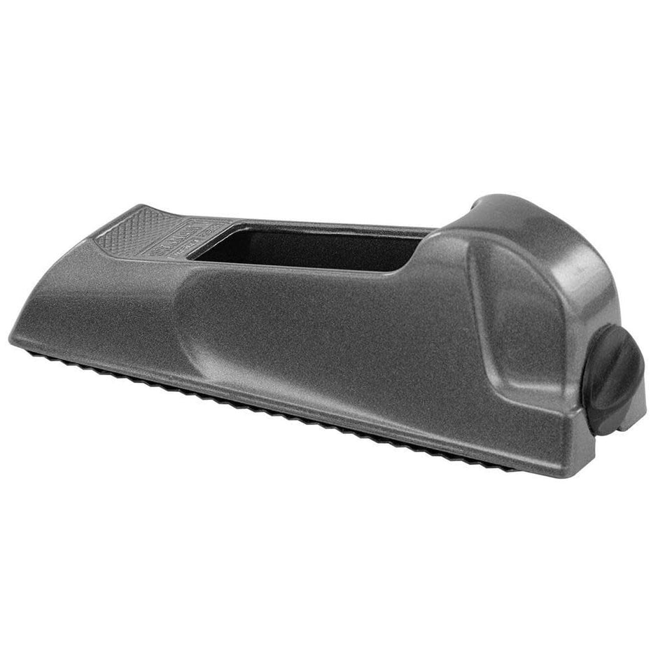 Profile view of the STANLEY 21-399 Surform pocket plane showing its contoured die-cast alloy body with a metallic grey finish and the black manual thumbscrew tension dial on the rear heel.