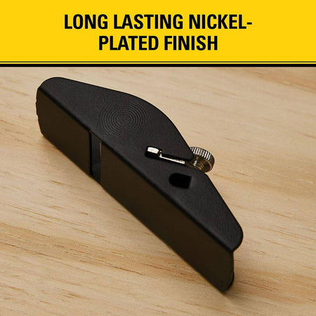 The underside and side flank profile of a black finish base sole on a STANLEY 12-101 trimming plane beneath a yellow commercial marketing banner reading long lasting nickel plated finish.