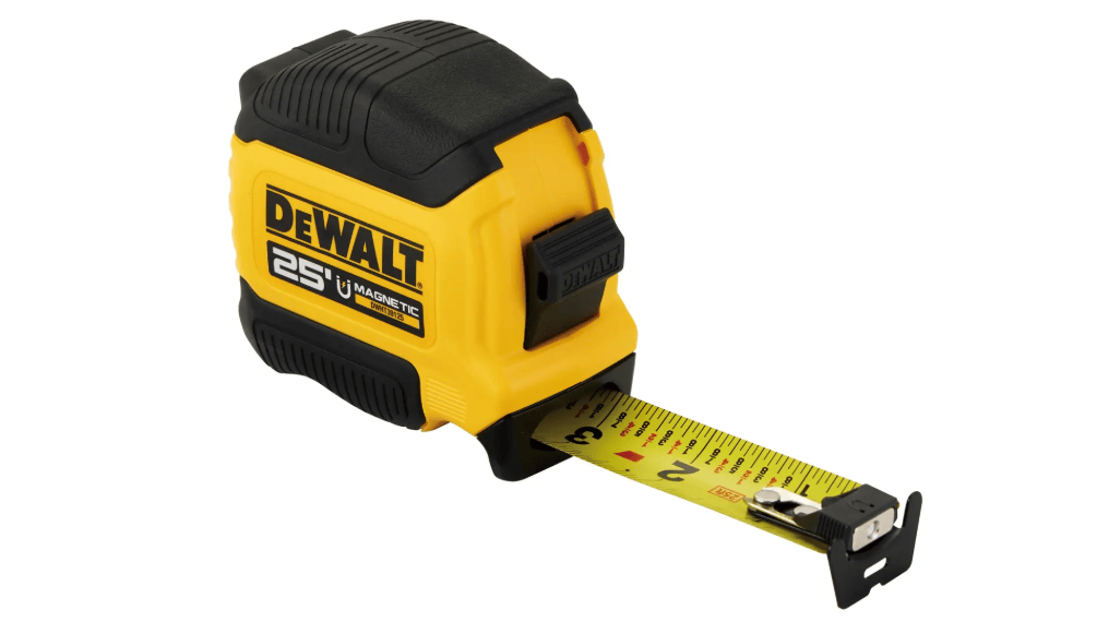 This image shows a DEWALT 25-foot magnetic tape measure resting on a white surface with a short length of its blade extended forward.