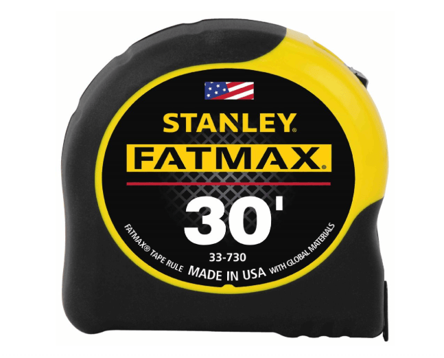 Stanley Fatmax 30-foot tape measure shown closed on a plain white background. The tape measure has a black and yellow plastic casing with a large black label featuring the yellow 'STANLEY FATMAX' branding, a small American flag graphic, and white text indicating '30"' and 'MADE IN USA'.