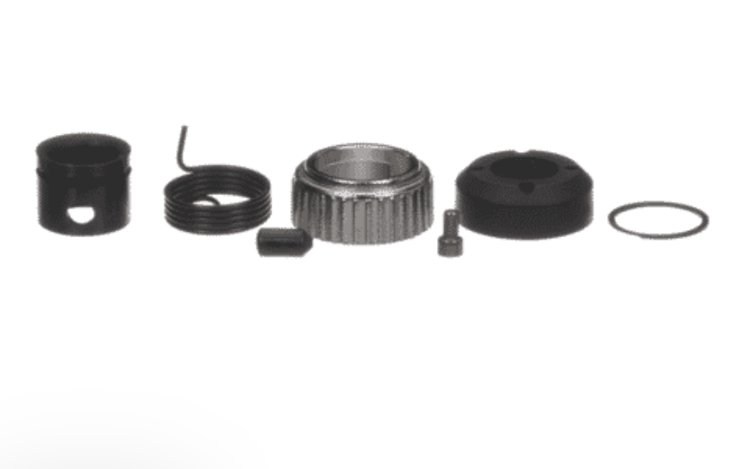 A set of small mechanical hardware parts arranged on a plain white background, including a cylindrical black component, a coiled spring, a ribbed metal ring, a small rectangular piece, a small bolt, and a rubber O-ring.