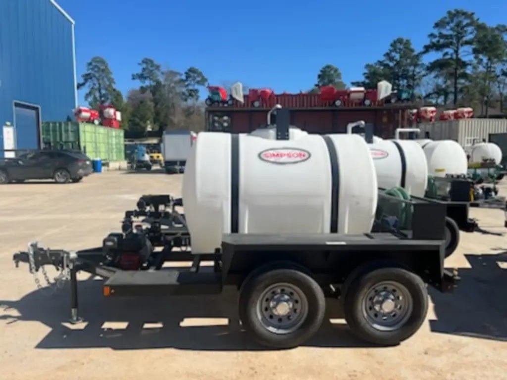 A side profile view of the Simpson 525-gallon mobile water trailer highlighting the high-density polyethylene tank, heavy-duty black steel frame, and premium dual-axle 16-inch tires for stable over-the-road transport.