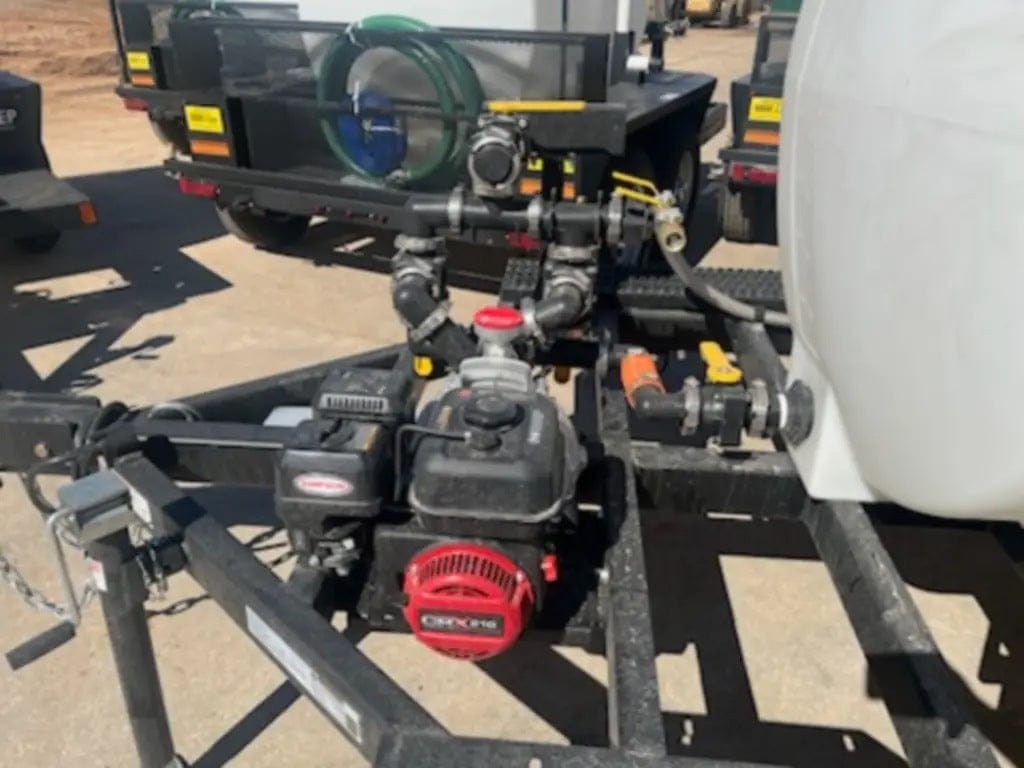 A close-up shot of the front equipment platform featuring the professional-grade Simpson engine and the 2-inch semi-trash pump capable of delivering a high-volume flow of 158 GPM.