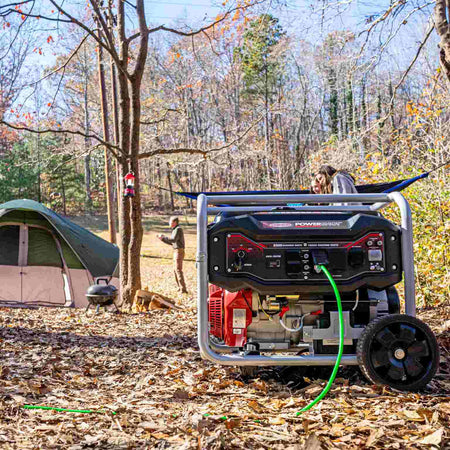Lifestyle image showing the portable generator set up in a wooded campsite with a tent and people relaxing in a hammock in the background.