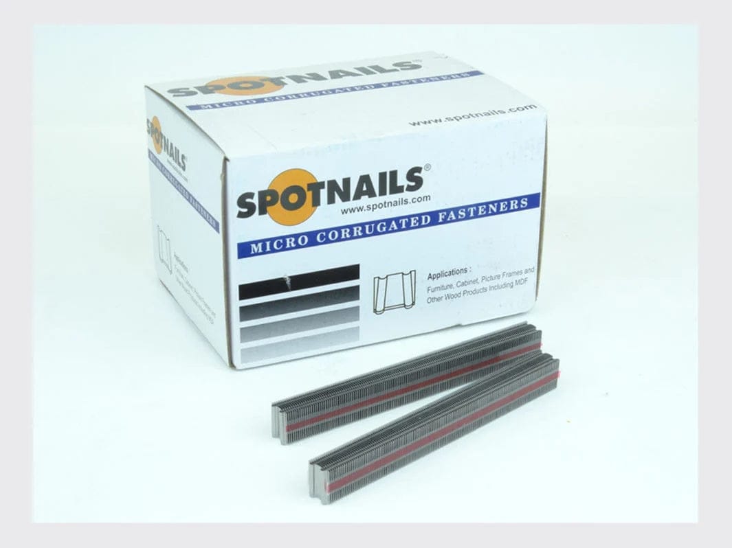Product shot showing the Spot Nails box labeled Micro Corrugated Fasteners and a partial stack of fasteners lying in front of the box.
