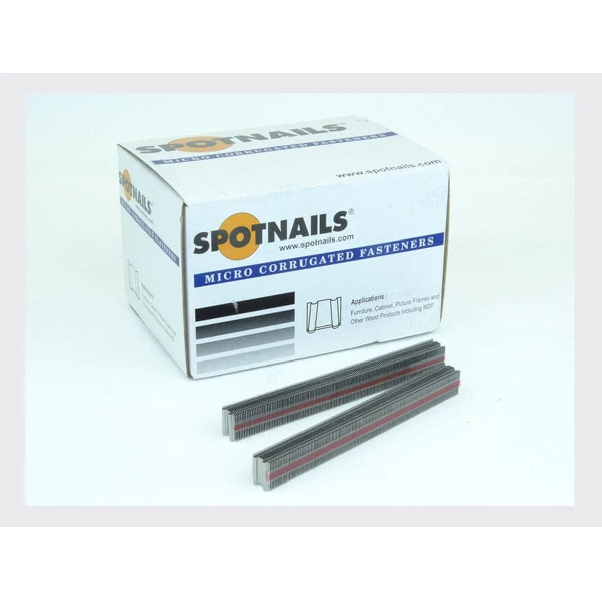 Product shot showing the Spot Nails box labeled Micro Corrugated Fasteners and a partial stack of fasteners lying in front of the box.