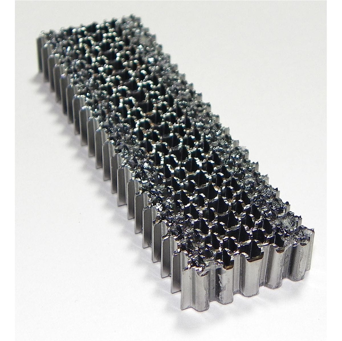 Top perspective view showing the divergent corrugated steel waves and straight strip collation of Spotnails 616-5M fasteners.