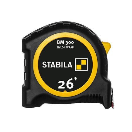 A profile view of the Stabila BM 300 26-foot pocket tape measure featuring a yellow and black shatterproof housing with high-impact soft grip casing and clear branding for the Nylon Wrap professional-grade blade.