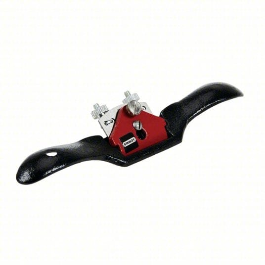 Studio view of the Stanley 12-951 flat base spoke shave featuring a black cast iron body with curved handles and a central red lever cap securing the blade.