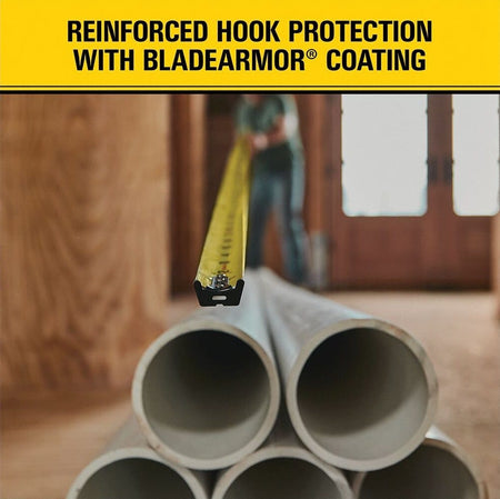Stanley FatMax 16 ft tape measure extended across stacked pipes, highlighting reinforced hook protection, BladeArmor coating, and durable wide blade engineered for demanding framing and industrial measurement tasks.