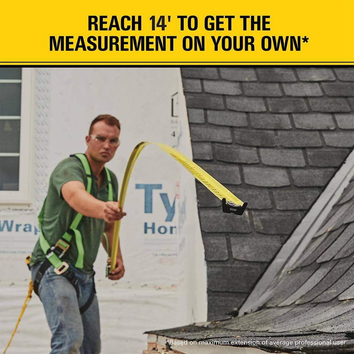 Action shot demonstrating a contractor using the 14-foot standout of the Stanley FATMAX tape measure to take an overhead measurement on a residential roofing project.