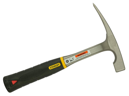 Angled profile view of the masonry hammer highlighting the sharp chisel point, the square striking face, and the safety warning label on the steel shaft.