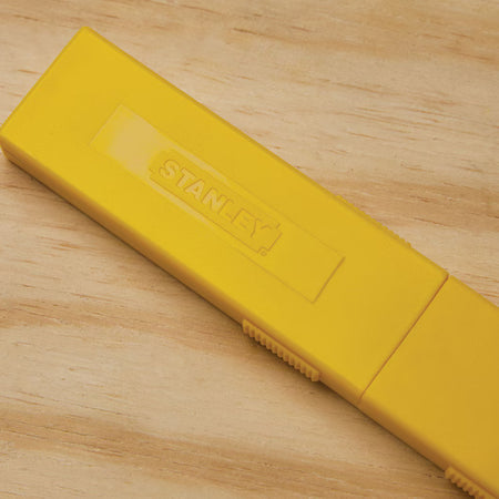 Yellow protective storage case for Stanley snap-off utility blades keeps replacement blades clean and easily identifiable on jobsites.