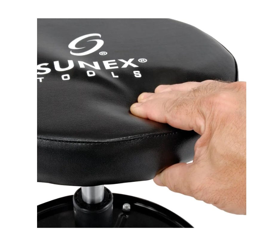 Close-up action shot of a hand pressing into the thick vinyl padded seat, demonstrating the cushioning and comfort of the stool.