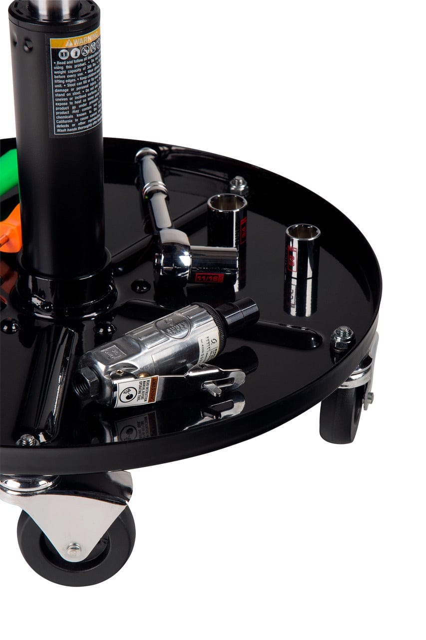 Close-up lifestyle view of the onboard tool tray holding various mechanic tools including a ratchet, sockets, and a pneumatic die grinder, illustrating the storage capacity.