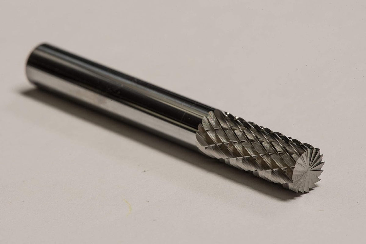 A close-up studio shot of the UCT Gem Carbide SB1 burr, highlighting the radius end and the double-cut flutes.