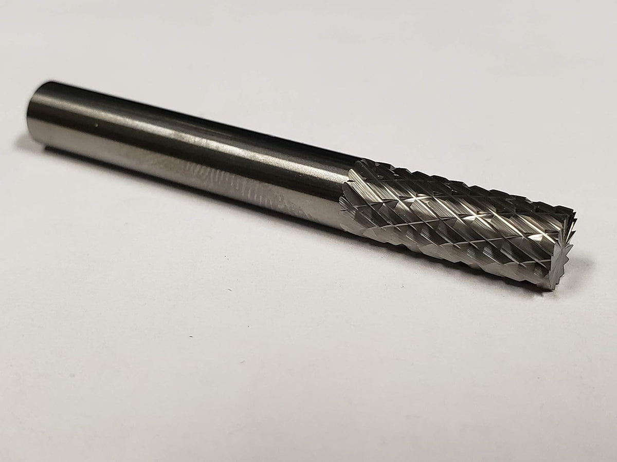 A studio shot of the UCT Gem Carbide SB1 burr lying on a white surface.