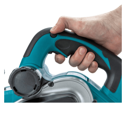 This is a close-up view of the rear handle and trigger of a Makita KP0810J planer being held by a hand. The handle is ergonomically shaped with teal and black textured grips for comfort and control. The index finger is positioned to activate the trigger switch located on the underside of the handle. You can also see a portion of the silver motor housing and a black adjustment knob on the side of the planer.