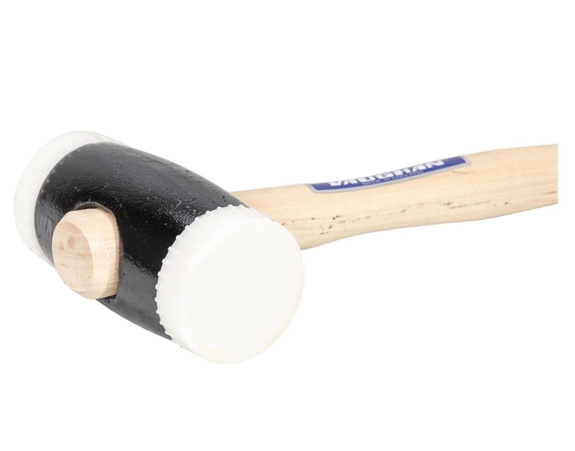 A close-up studio shot focusing on the black head and white replaceable faces of the Vaughan NT250 hammer.