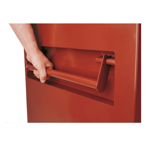 Close up of handle. This is a close-up shot of a hand pulling a red handle protruding from a red metal surface. The handle is horizontal and appears to be part of a door or drawer.