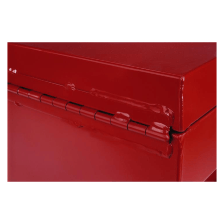 Close up of hinge. This is a close-up shot of the corner of a red metal box with a hinged lid. The hinge runs horizontally along the edge of the box, and the red surface is glossy.