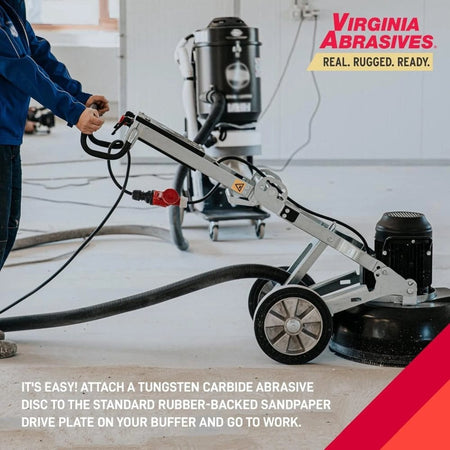 Person operating a floor buffer connected to a vacuum system in a clean indoor space. Virginia Abrasives branding and usage instructions visible.
