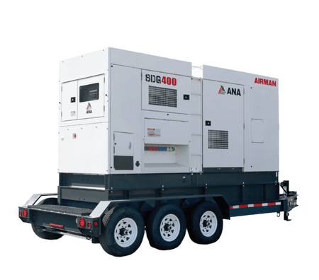 This is a large, industrial generator housed in a white, boxy enclosure. The entire unit is mounted on a black, triple-axle trailer, indicating that it is designed to be mobile for use at construction sites or for temporary power needs. Various access panels, vents, and branding like "AIRMAN" and "SDG400" are visible on its side.
