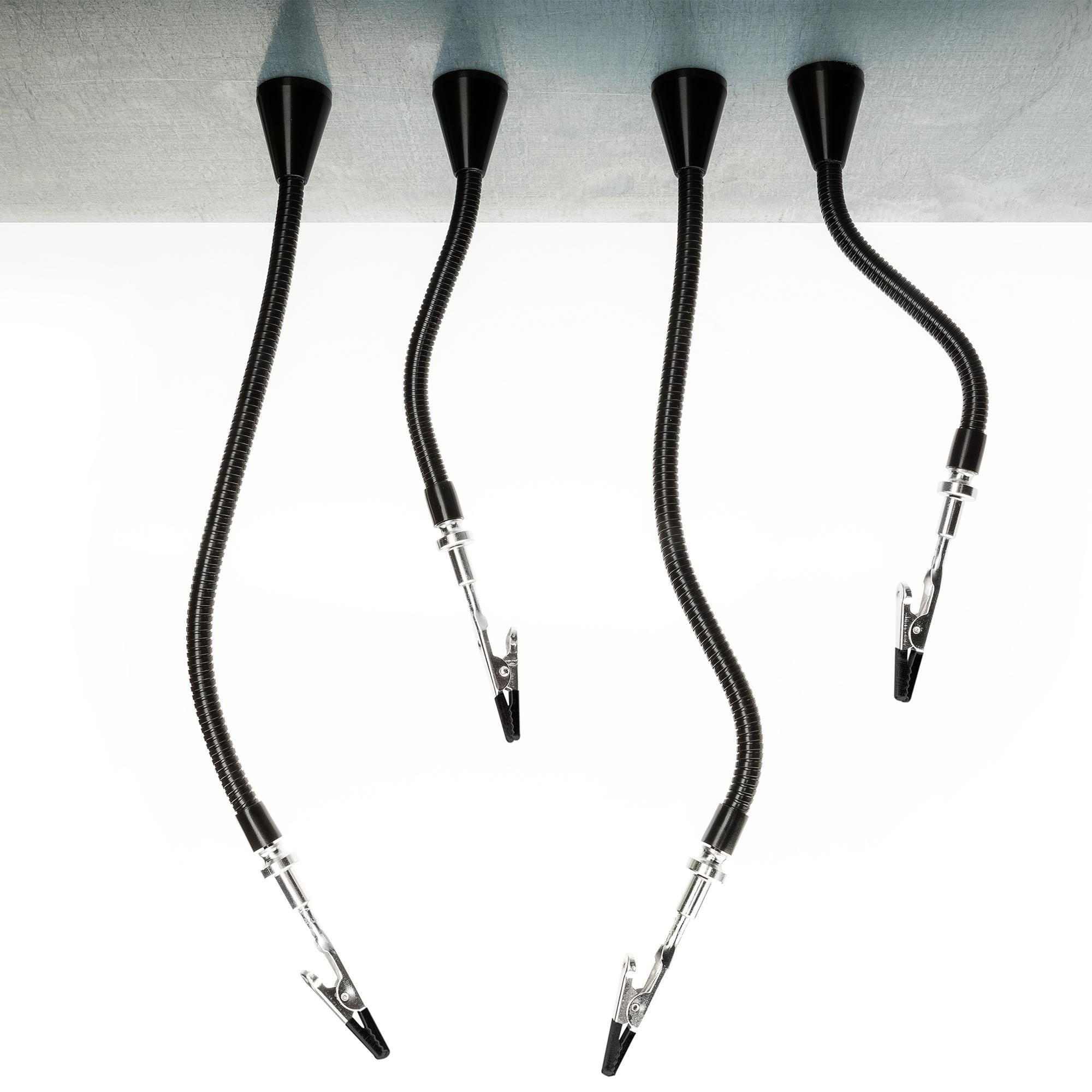 Four flexible gooseneck arms with clips mounted to workbench edge, used for holding components during soldering.
