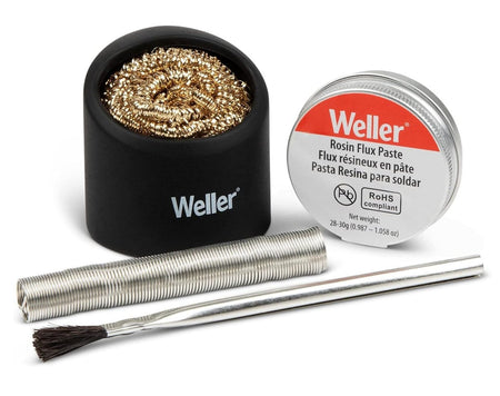 A studio product shot of the Weller WCACCK2 soldering accessory kit including lead-free solder wire, a tin of rosin flux paste, an application brush, and a brass wire tip cleaner in a black silicone holder.