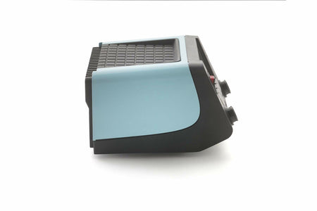 Side view of a vintage electronic device with light blue panel, black base, and grid-patterned top. Front panel includes knobs and buttons. Design suggests mid-20th century origin, possibly a typewriter or early terminal.