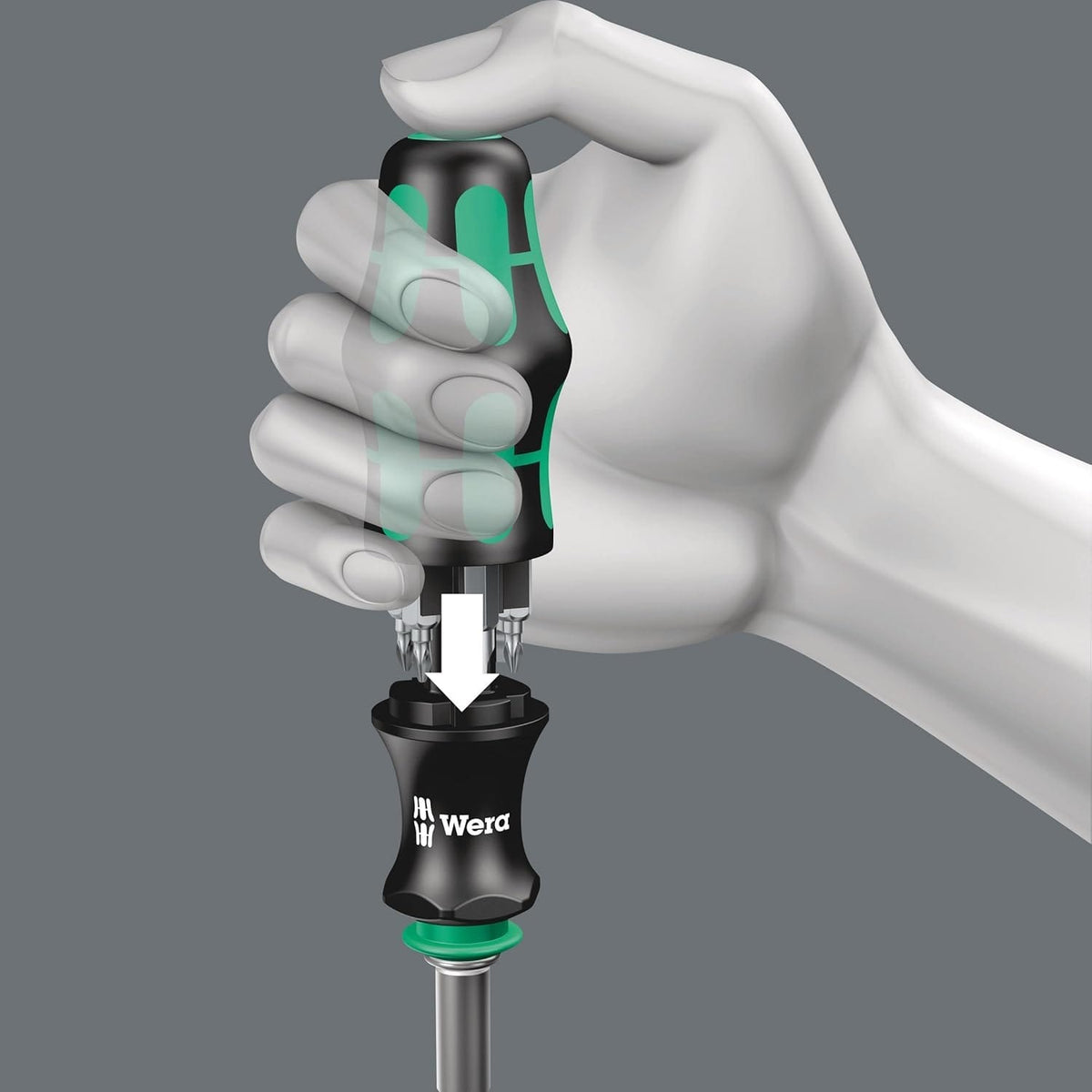 Instructional graphic showing a hand engaging the bit storage magazine of the Wera Kraftform handle by pressing the green release button at the base of the grip.