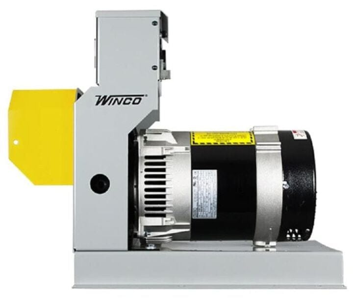 Rear side view showing the black cylindrical generator head, grey steel mounting base, and the yellow PTO input guard.