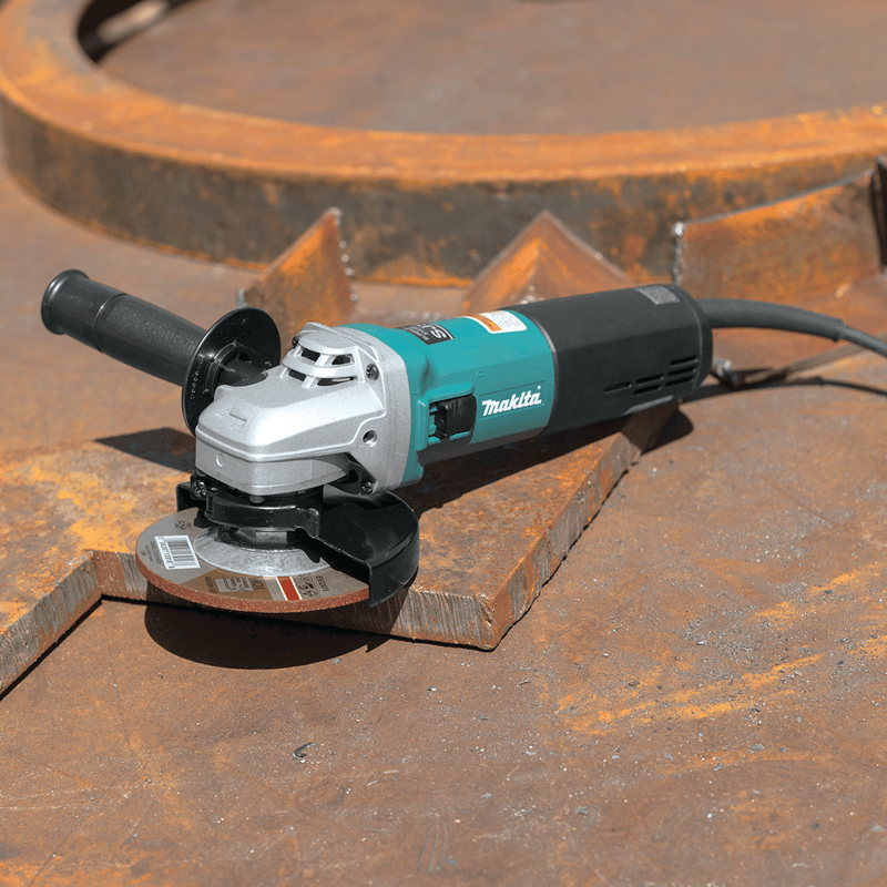 Makita angle grinder on a rusty metal surface