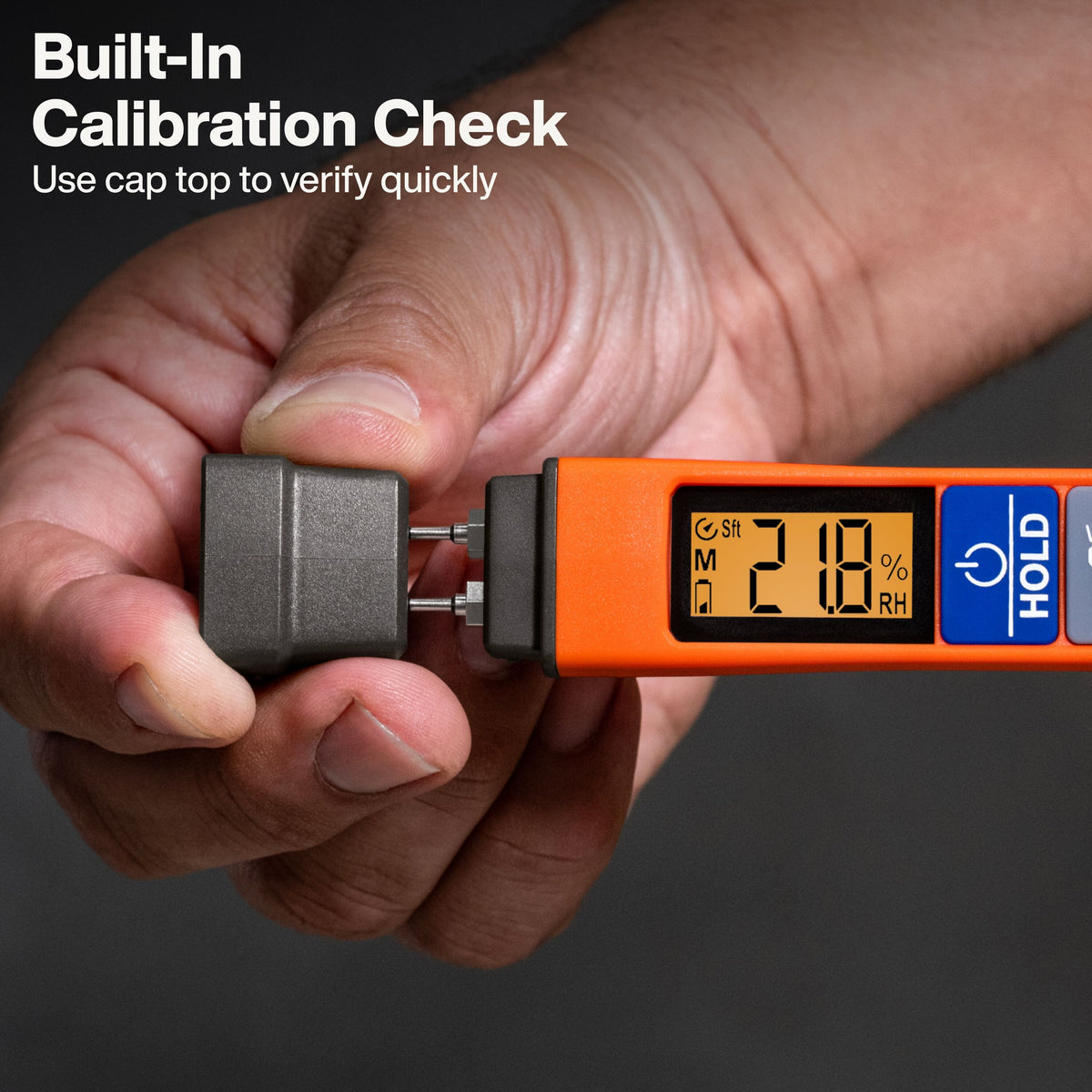 A close-up of a hand holding an orange and black digital hygrometer to verify calibration with its included gray cap. White text in the upper left reads 'Built-In Calibration Check' and 'Use cap top to verify quickly'.